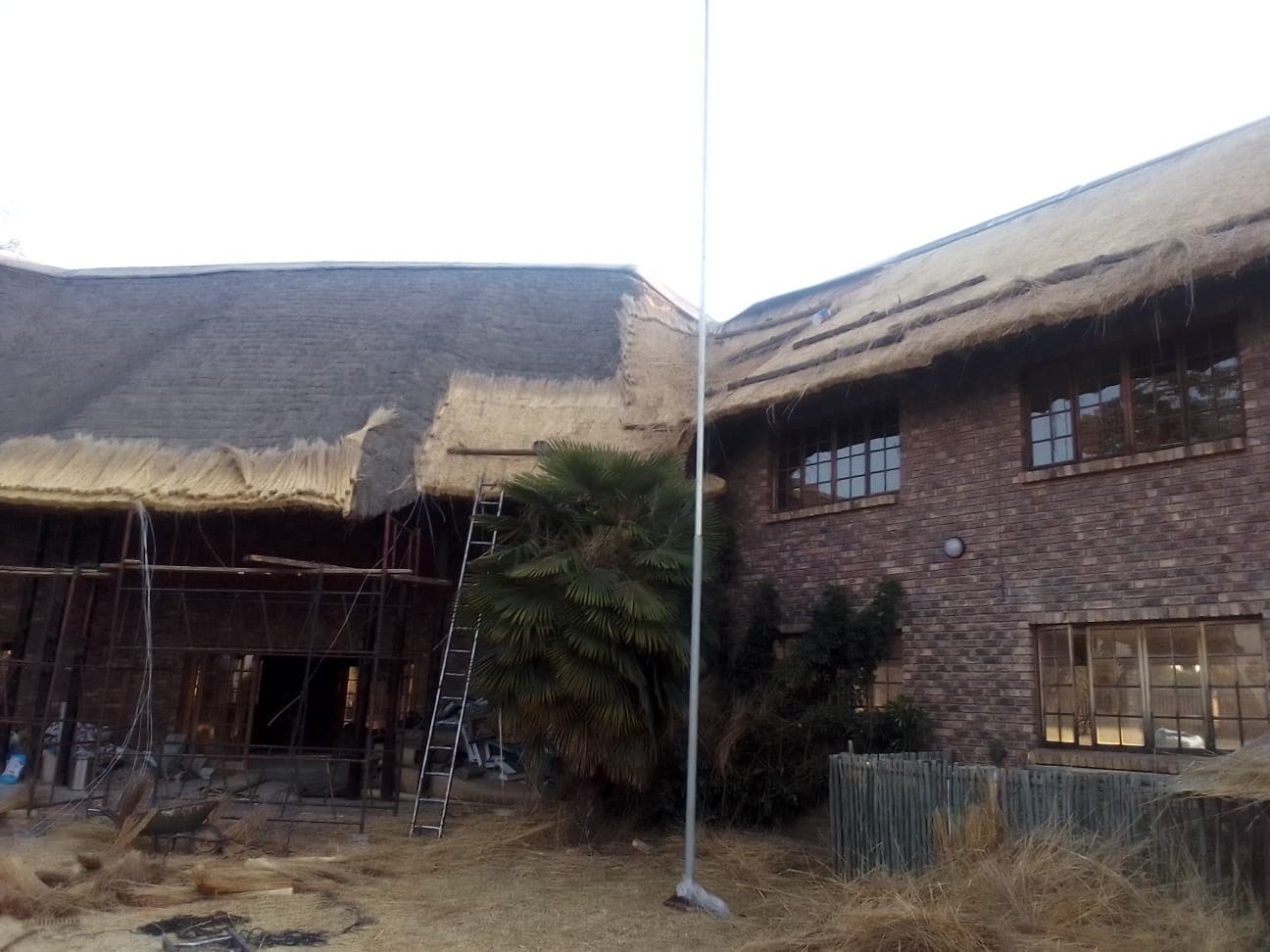 Re-thatching a residential thatch roof with premium reed